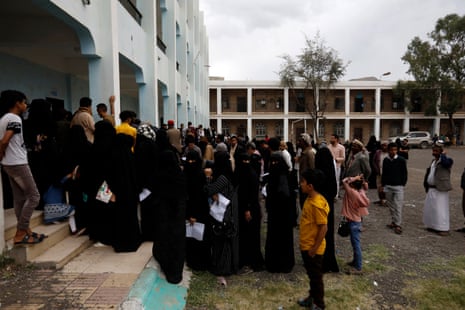 Yemenis wait to receive food rations at an aid distribution centre of the World Food Programme in Sana’a on 17 May.