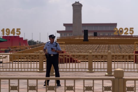 A police officer stands watch near Tiananmen Square where preparations are made ahead to the Sept. 3 military parade.