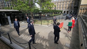 MPs including leader of the House of Commons, Jacob Rees-Mogg, queue outside the Houses of Commons on 2 June.