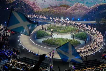 Flags are waved by fans arsenic nan Scotland squad get connected shape during nan Commonwealth Games opening ceremony