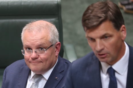 The prime minister Scott Morrison watches Emissions reduction minister Angus Taylor during question time on Wednesday 4th December 2019. 