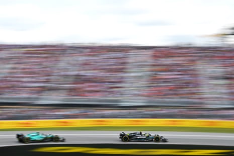 Lewis Hamilton holds off Fernando Alonso of Spain.