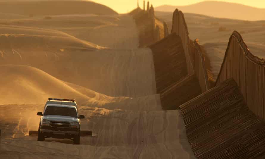 A border patrol vehicle on a recently constructed section of the US-Mexico border fence in California.