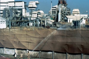 1984: Firemen hose water over canvas screens at factory boundaries to prevent the spread of dangerous fumes at the Union Carbide plant in Bhopal, India.