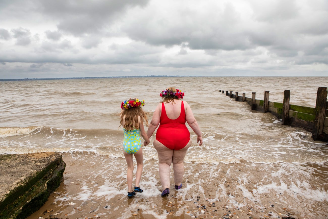 Anna Morell and her daughter Aurelia go into the water at All Hallows Beach in Kent.