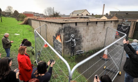 People gather to take picture of the Banksy in December