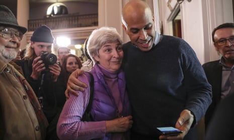 Cory Booker prepares to take a selfie with a supporter in Manchester.