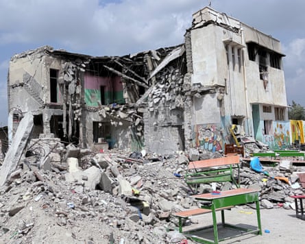 A ruined school hit by a bomb. The front of the building has been ripped off.