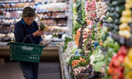 A customer shops for produce at a Whole Foods Market in Oakland, California.