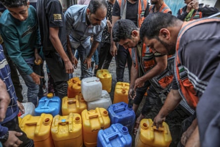 Palestinians stand in line to get water in the city of Rafah.