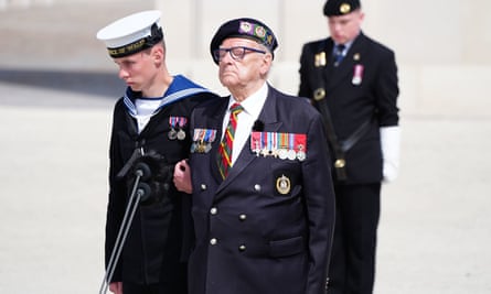 Ken Hay stands assisted by young man during the memorial