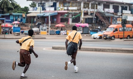 Schoolchildren run across Accra’s George W Bush highway.