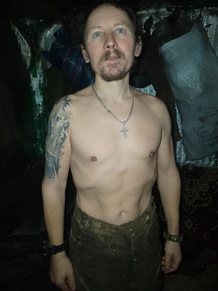 An emaciated soldier standing with his shirt off