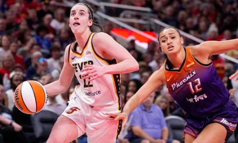 Indiana Fever guard Caitlin Clark, left, drives past Phoenix Mercury's Celeste Taylor in the second half of Friday’s game.