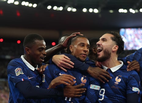 Michael Olise (centre) celebrates with Rayan Cherki (right) and Pierre Kalulu after opening the scoring.