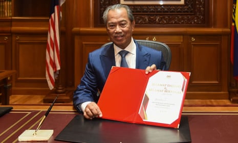 Malaysia’s new prime minister, Muhyiddin Yassin, posing for pictures
