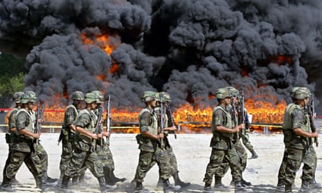 Mexican soldiers walk next to the site of the incineration of 23.5 tons of cocaine in Manzanillo in 2007, a week after the Mexican and US governments announced a joint security plan that includes a Mexican pledge to step up the fight against organized crime, especially drug trafficking.