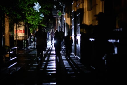 People walk down a street during a blackout in Spain