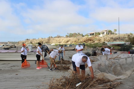 People in San Juanico sweeping the beach clean