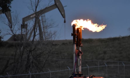 A flare burns at an oil well in North Dakota, US