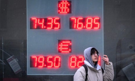 A pedestrian passes a currency exchange office in Moscow