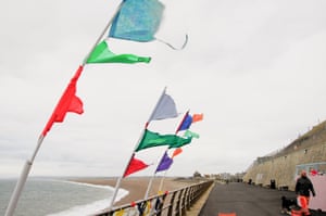 Storm Caroline makes flags flutter on Chesil beach in Dorset.