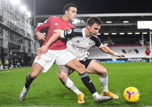 Joe Bryan of Fulham tussles with Mason Greenwood of Manchester United.