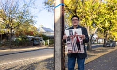Don Violi holding a photograph next to a stobie pole