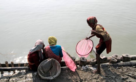 Girls catch fish on the banks of the Ganges in India.
