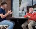 Two men sitting opposite each other at a table outside a restaurant