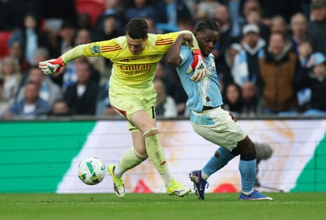 Manchester City's Jeremy Doku in action with Arsenal's Kepa Arrizabalaga.