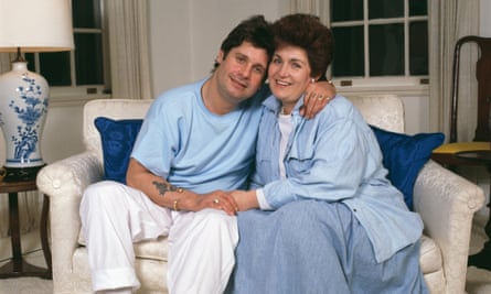 Ozzy and Sharon Osbournein 1987, hugging and holding hands on a sofa wearing ordinary clothes