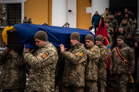Soldiers carry the coffin of Eduard Strauss, a Ukrainian serviceman killed in combat in Bakhmut, after a farewell ceremony at the Roman Catholic Parish of Saint Alexanders in Kyiv.