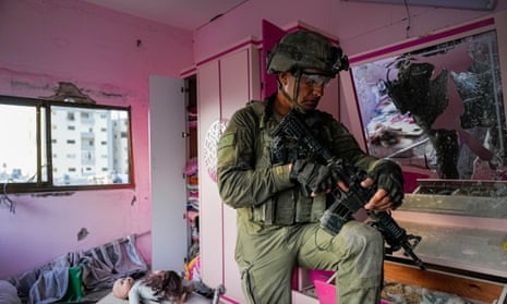 An Israeli soldier stands in a child’s bedroom in an apartment during a ground operation in the Gaza Strip, Wednesday 8 November 2023.