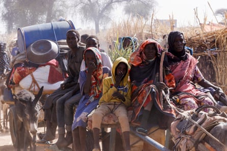 People huddle on the back of a cart