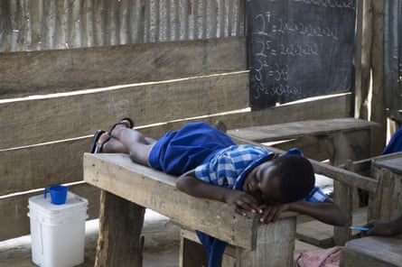 A student sleeps at the only school in the farming community of Apprah. Most students at school are malnourished, and many fall asleep during the day or have problems concentrating in class