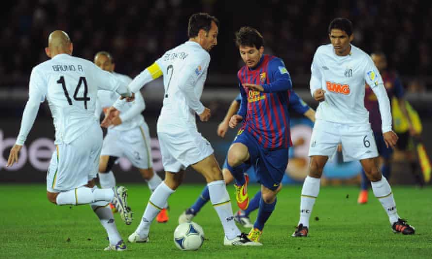 Lionel Messi, not known as a diver, dribbles past his Brazilian opponents in the club World Cup final.