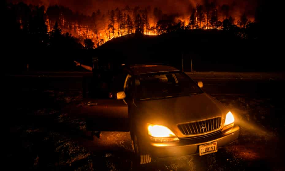 US-FIRE<br>People stop on the side of the road to watch as the Glass Fire slowly blazes down the hill side outside of Calistoga in Napa Valley, California on September 28, 2020. - The wildfire went from 1,500 acres to more than 15,000 acres overnight as winds spread embers across the valley. Tens of thousands of people were forced to flee their homes in California’s Napa and Sonoma valleys on Monday as wildfires fanned by fierce winds ripped through the world-famous wine region. (Photo by Samuel Corum / AFP) (Photo by SAMUEL CORUM/AFP via Getty Images)
