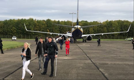 Passengers leave the plane at Stansted airport after the security alert. 