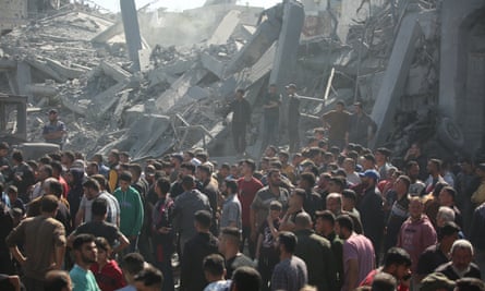 Crowd of people in the rubble of a destroyed home