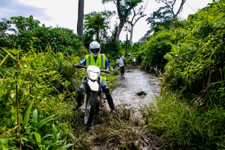 An MSF team on motorbikes in the middle of the bush trying to reach the Lungonzo area to deliver vaccines.