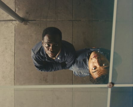 two men looking up into a mirrored image of themselves