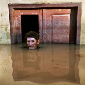 João Pereira de Araújo in Taquari District, Rio Branco,Brazil ouside his flooded home