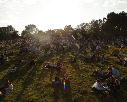 Oasis fans gather on ‘Gallagher Hill’ at sunset, on 16 July 2025