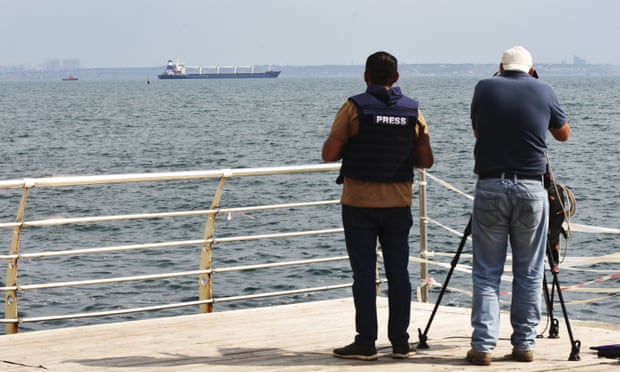 Media cover as the bulk carrier Razoni starts its way from the port in Odesa, Ukraine, Monday, Aug. 1, 2022. According to Ukraine's Ministry of Infrastructure, the ship under Sierra Leone's flag is carrying 26 thousand tons of Ukrainian corn to Lebanon. The first ship carrying grain set off from the port of Odesa on Monday under an internationally brokered deal and is expected to reach Istanbul on Tuesday, where it will be inspected, before being allowed to proceed. (AP Photo/Michael Shtekel)