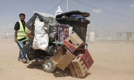 Muhammed Abu Najib Temeki, 48, a father of nine from Deraa in Syria pushes a cart of recyclable waste