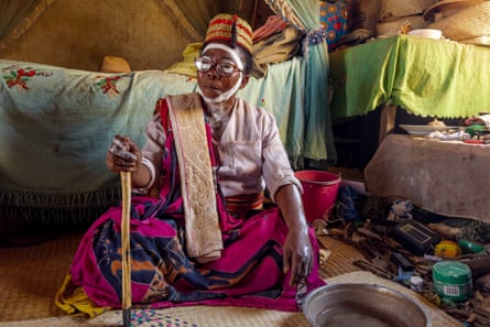 A traditional healer sitting in a hut