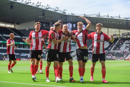 Lincoln’s Ben House, centre, celebrates scoring their opener against Derby.