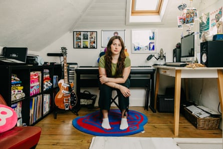 Portrait Adele Zeynep Walton in her sister Aimee’s bedroom surrounded by art, a guitar and computer, at her family home in Southampton