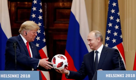 President Donald Trump receives a football from Russian president Vladimir Putin as they hold a joint news conference after their meeting in Helsinki, Finland July 16, 2018.